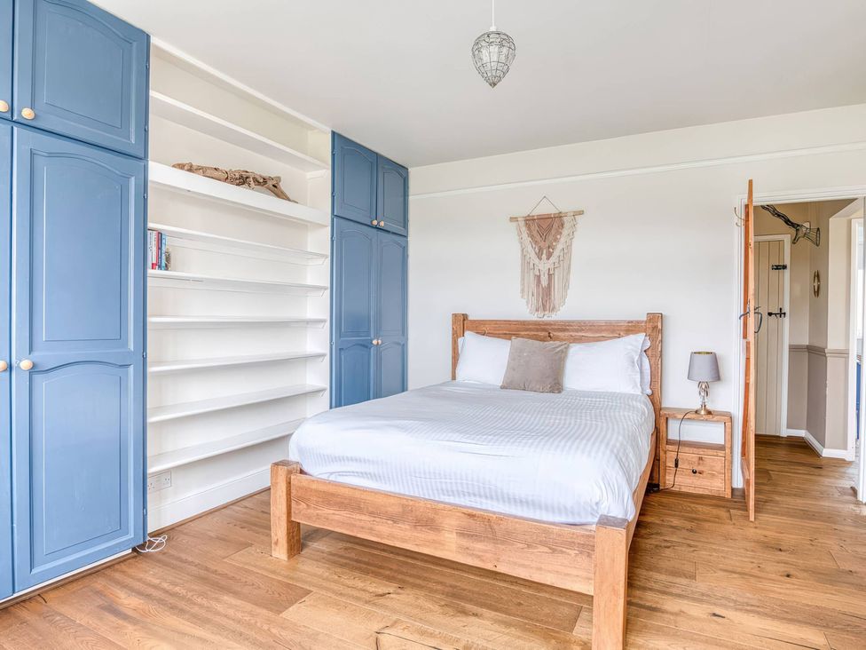 A bedroom with a bed and wardrobe at TBC