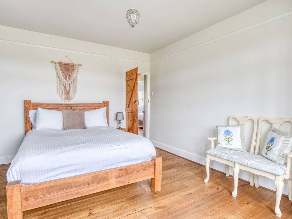 A bedroom with a bed and chairs at TBC 