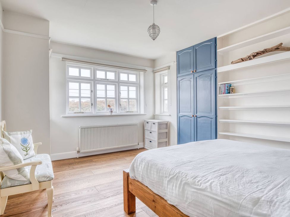 A bedroom with a bed and a wardrobe at TBC 