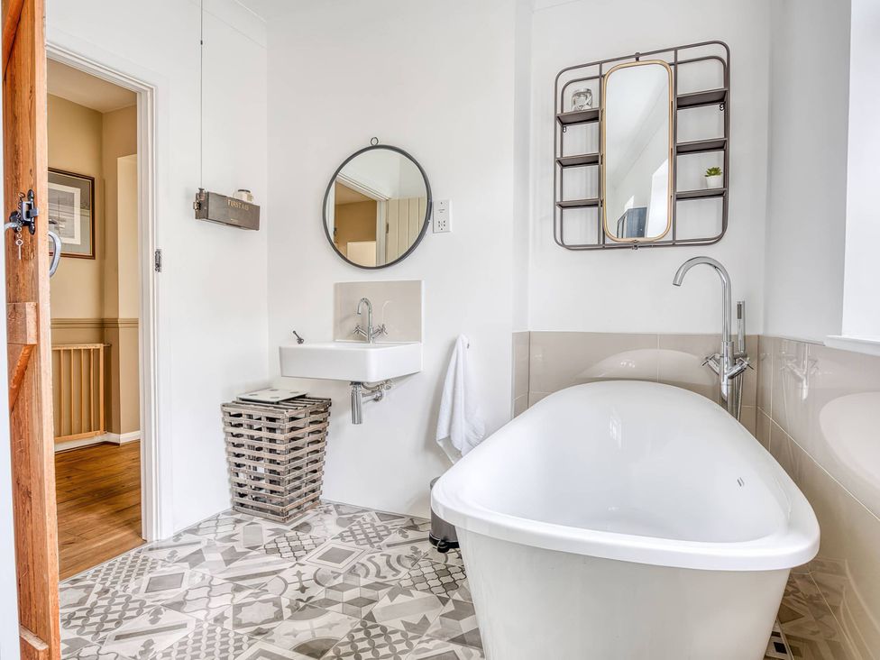 A bathroom featuring a bathtub and sink at TBC in 
