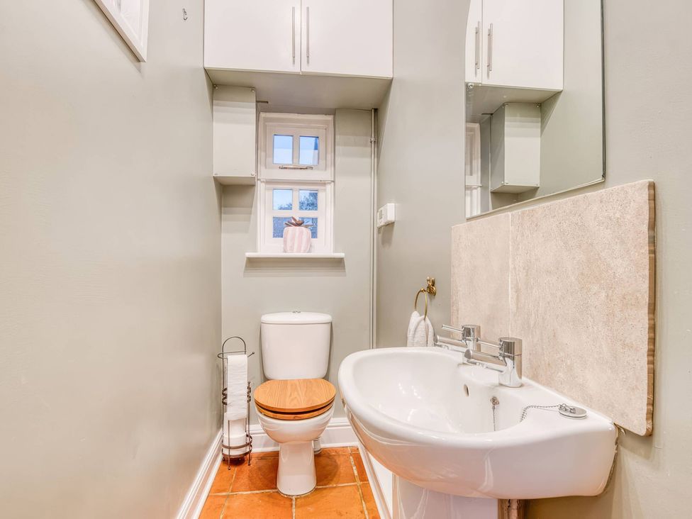 A bathroom with a toilet and sink at TBC