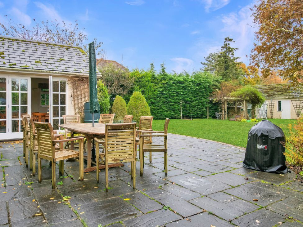 A patio area with a dining table and chairs at TBC in 