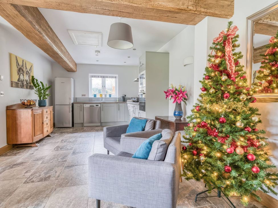 A kitchen with a Christmas tree and a countertop at TBC in 