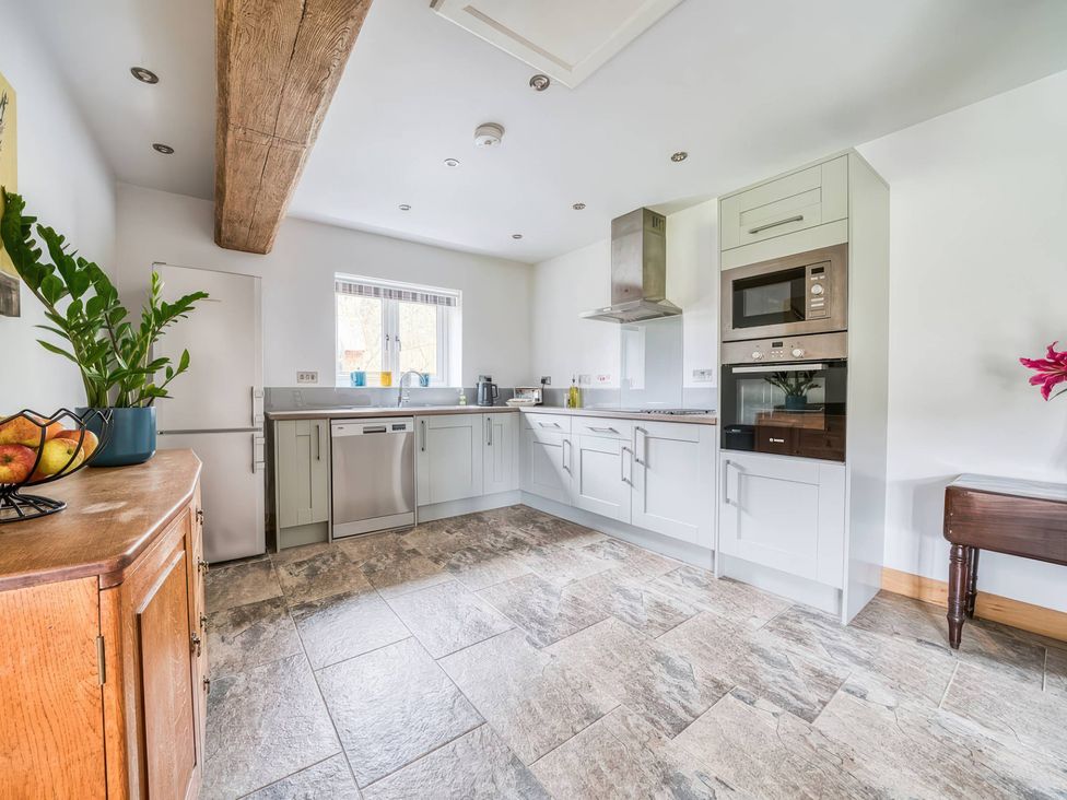 A kitchen with appliances and cabinets at TBC