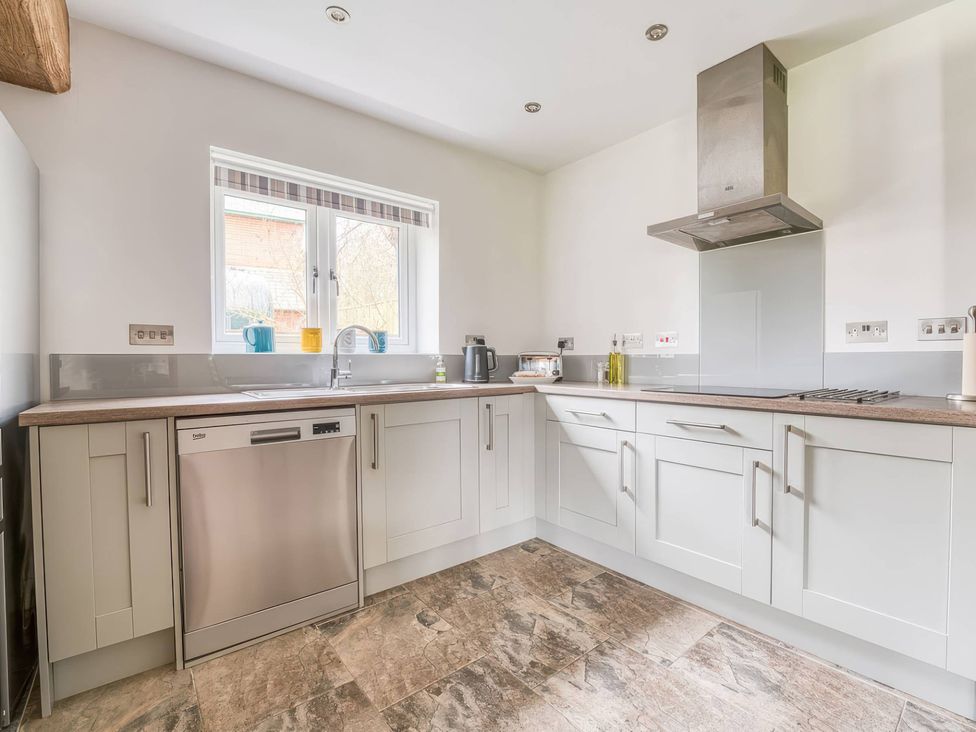 A kitchen with appliances and a window at TBC in 