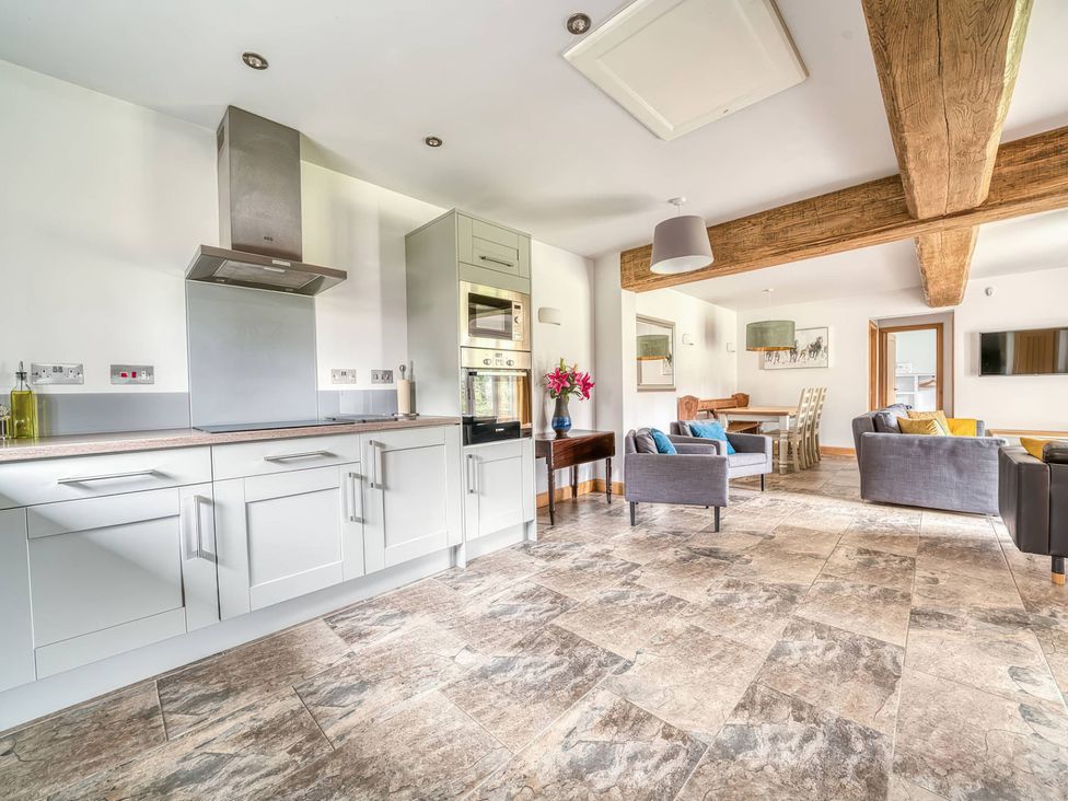 A kitchen with appliances and a dining area at TBC