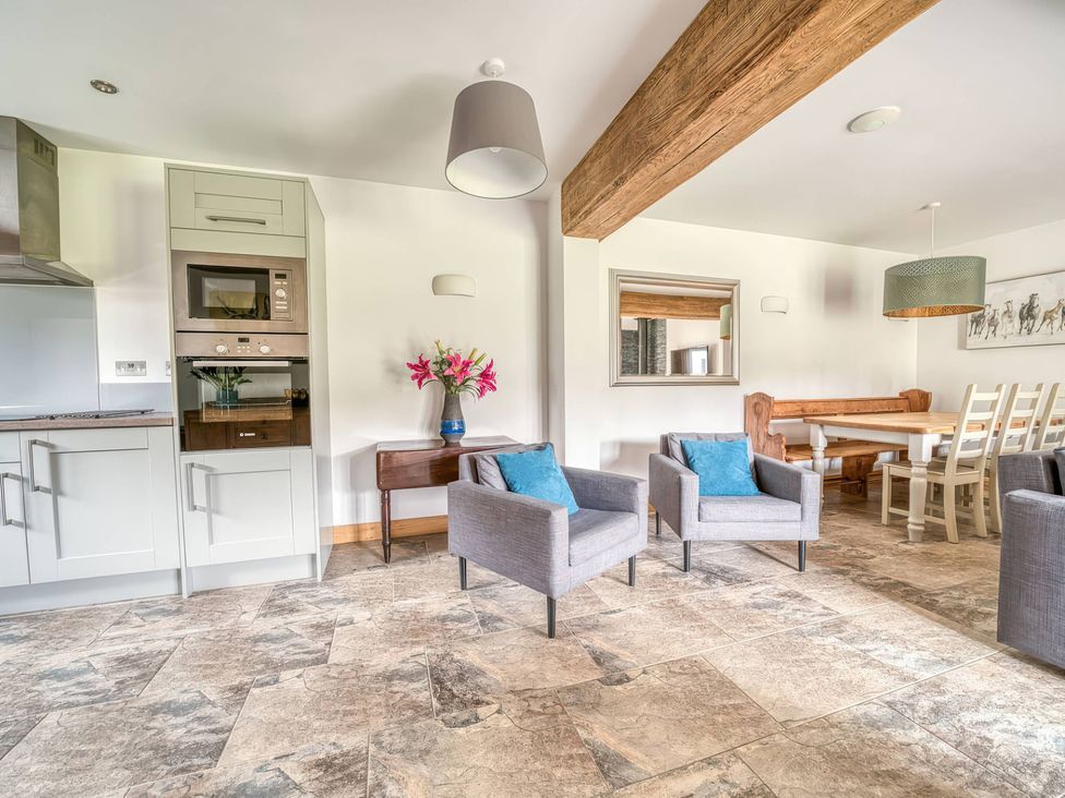 A kitchen with dining area and two chairs at TBC