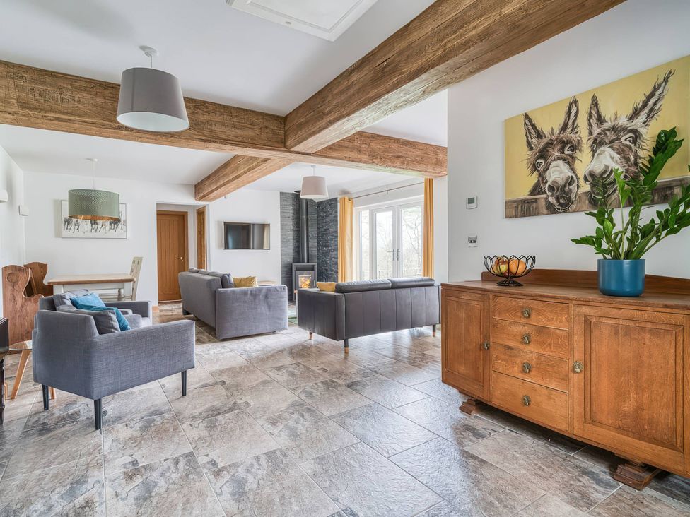 A living room with sofas and a dining table at TBC
