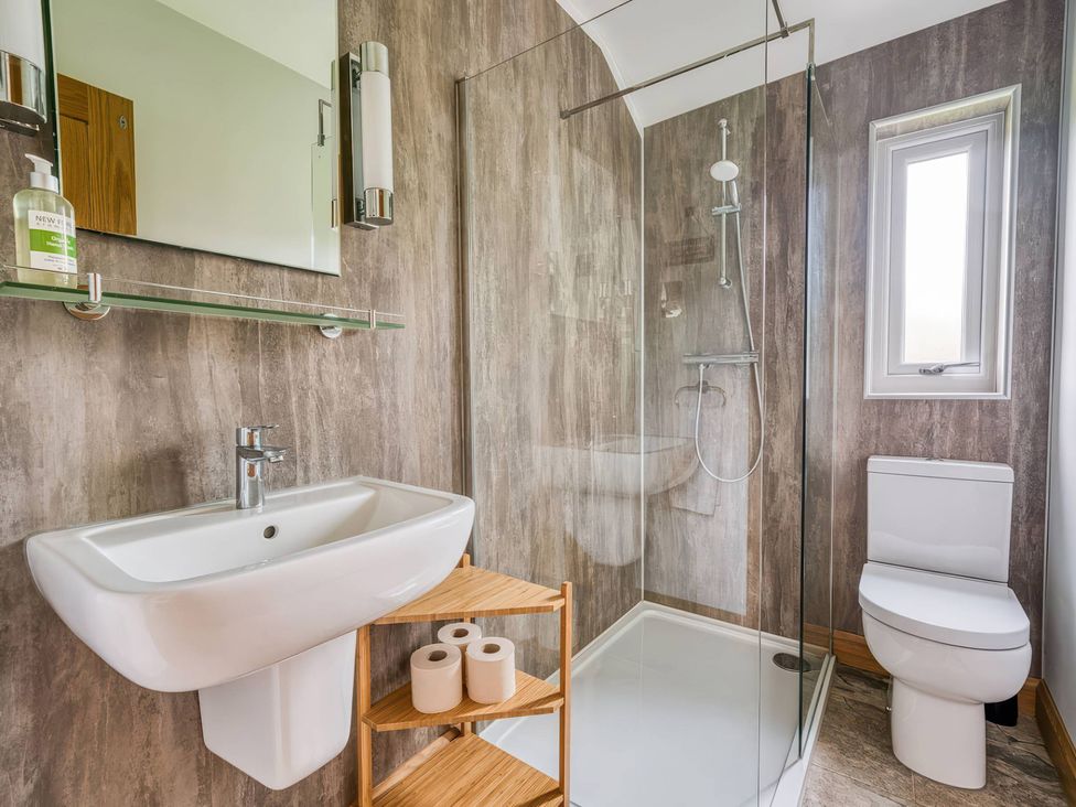 A bathroom featuring a sink, shower, and toilet at TBC 