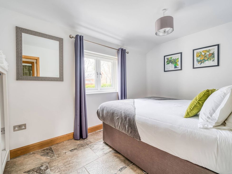 A bedroom with a bed and window at TBC 