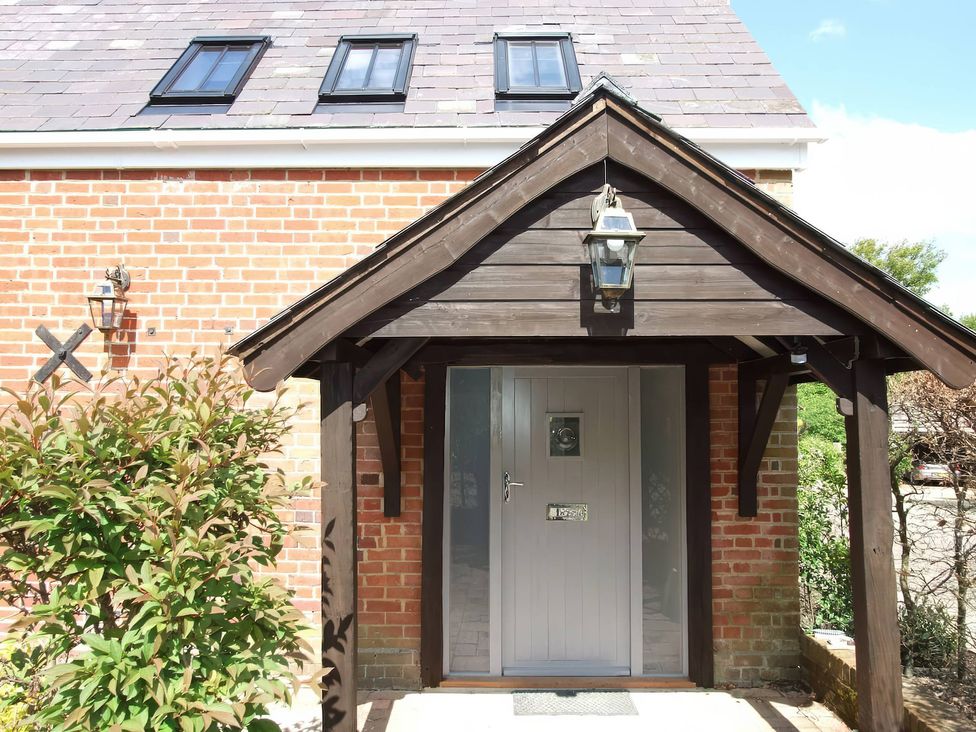 An entrance with a door and lantern at TBC in 