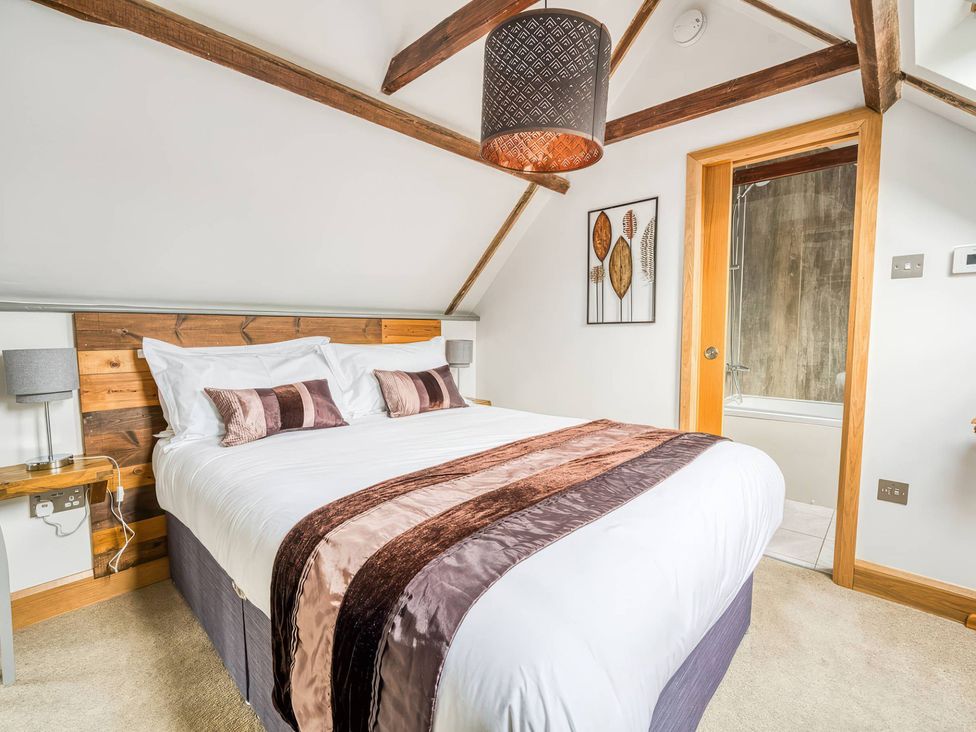 A bedroom with a bed and wall art at TBC 