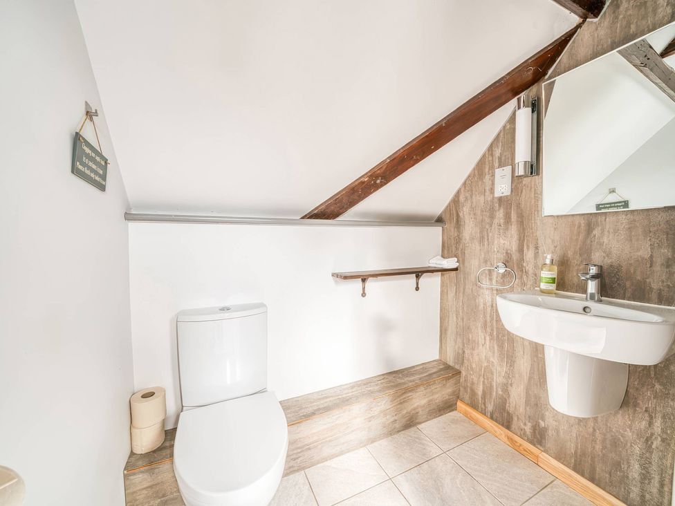 A bathroom with a toilet and sink at The Old Barn in 