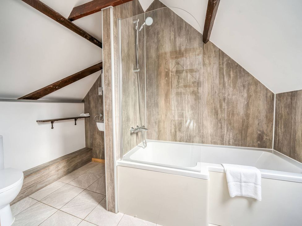 A bathroom with a bathtub and toilet at TBC