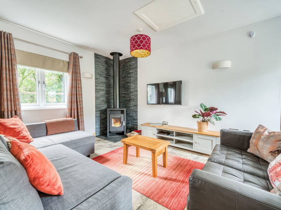 A living room with sofa and fireplace at TBC in 