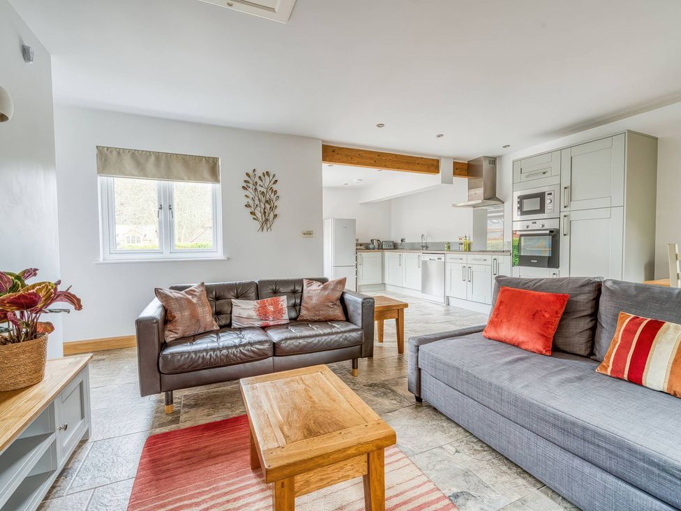 A living room with a sofa and coffee table at TBC