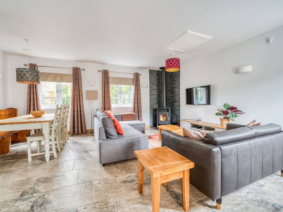 A living room with a dining table and sofa at TBC