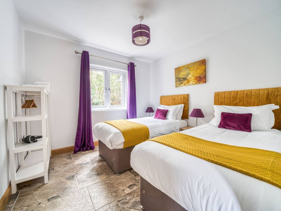A bedroom with two beds and a window at TBC in 