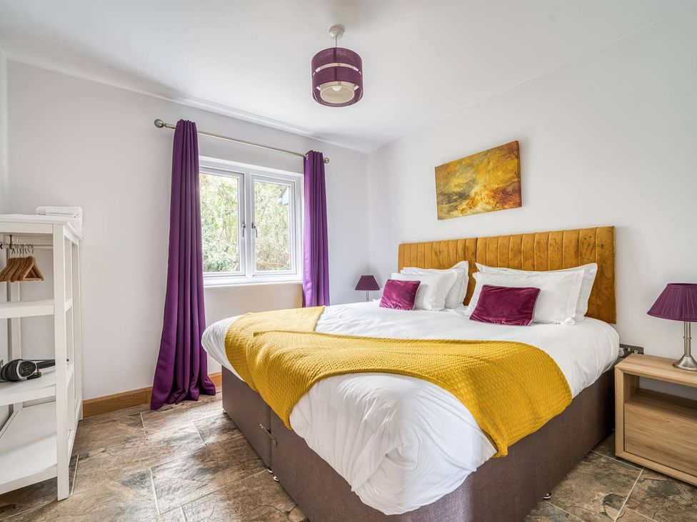 A bedroom with a bed and window at TBC