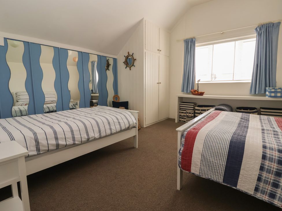 A bedroom with two beds and a window at Tapestry House in Bridlington