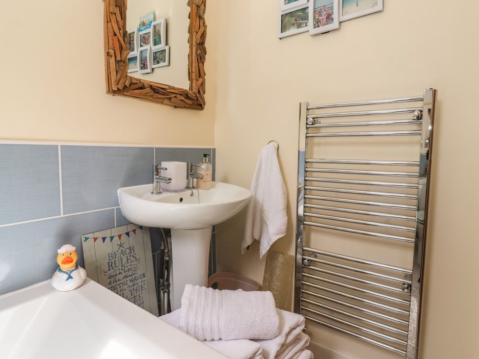 A bathroom with a sink and a towel rail at Tapestry House in Bridlington