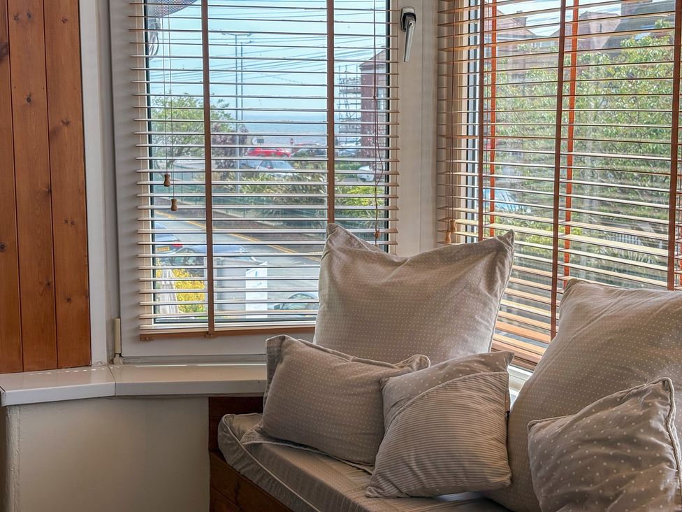 A living room with cushions on a bench at Tapestry House in Bridlington