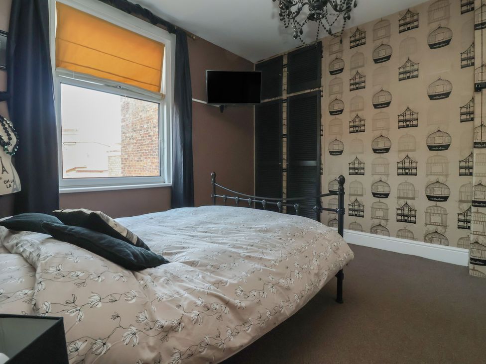 A bedroom with a bed and window at Tapestry House in Bridlington