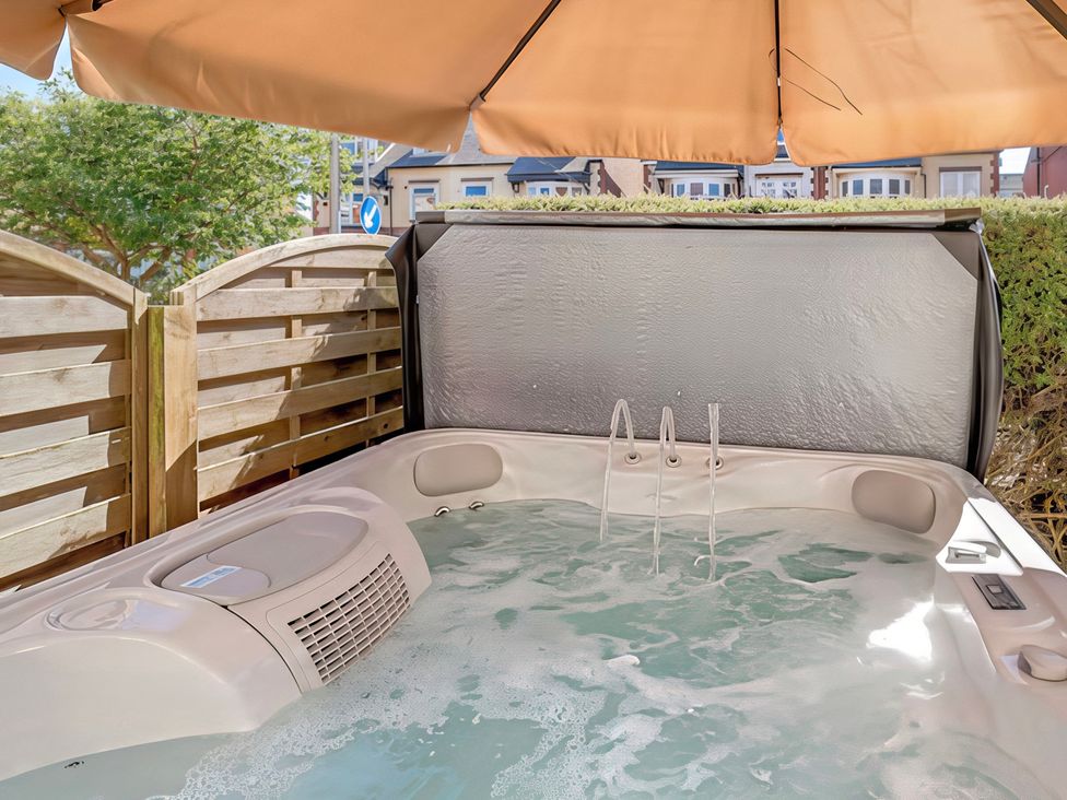 A hot tub with water jets in an outdoor area at Tapestry House in Bridlington