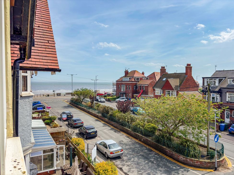 A seaside view with cars and houses at Tapestry House in Bridlington