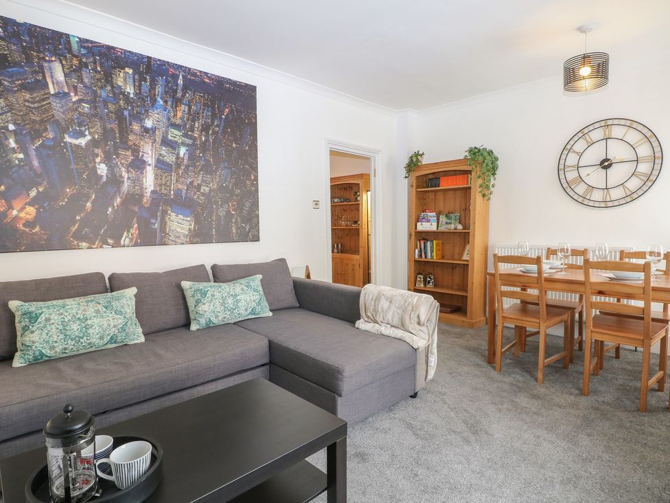 A living room with a sofa and dining area at Foreshore in Deal
