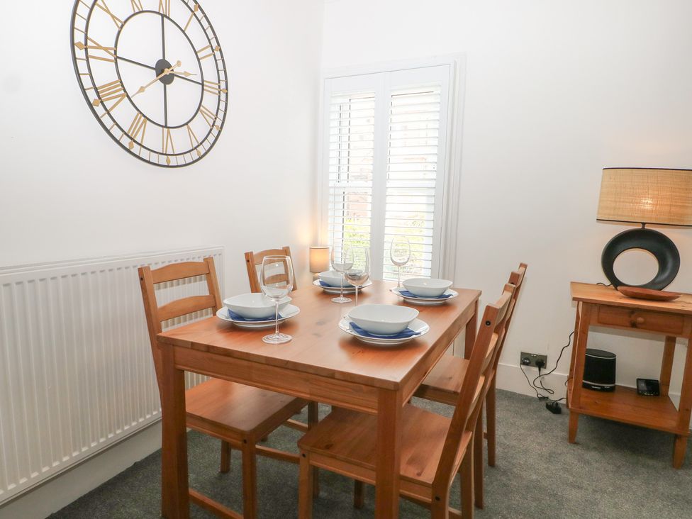 A dining room with a table and chairs at Foreshore in Deal