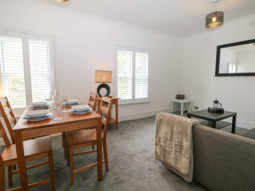 A dining room with a table and chairs at Foreshore in Deal