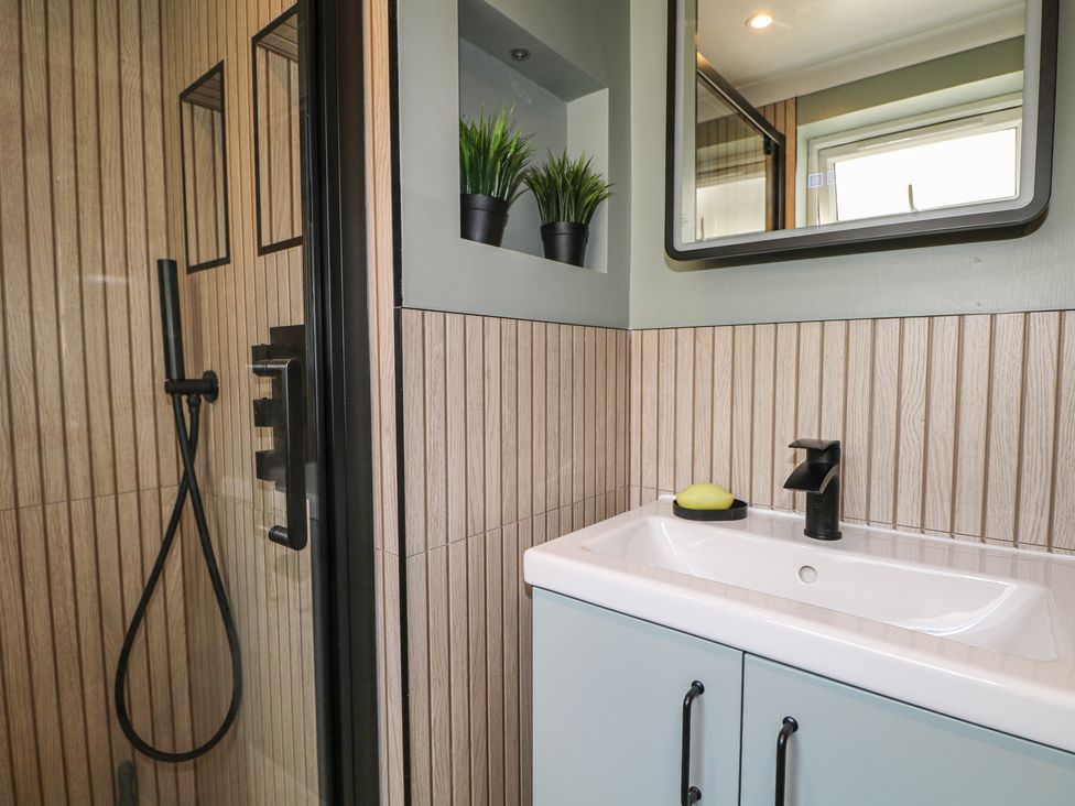 A bathroom with a shower and sink at Foreshore in Deal