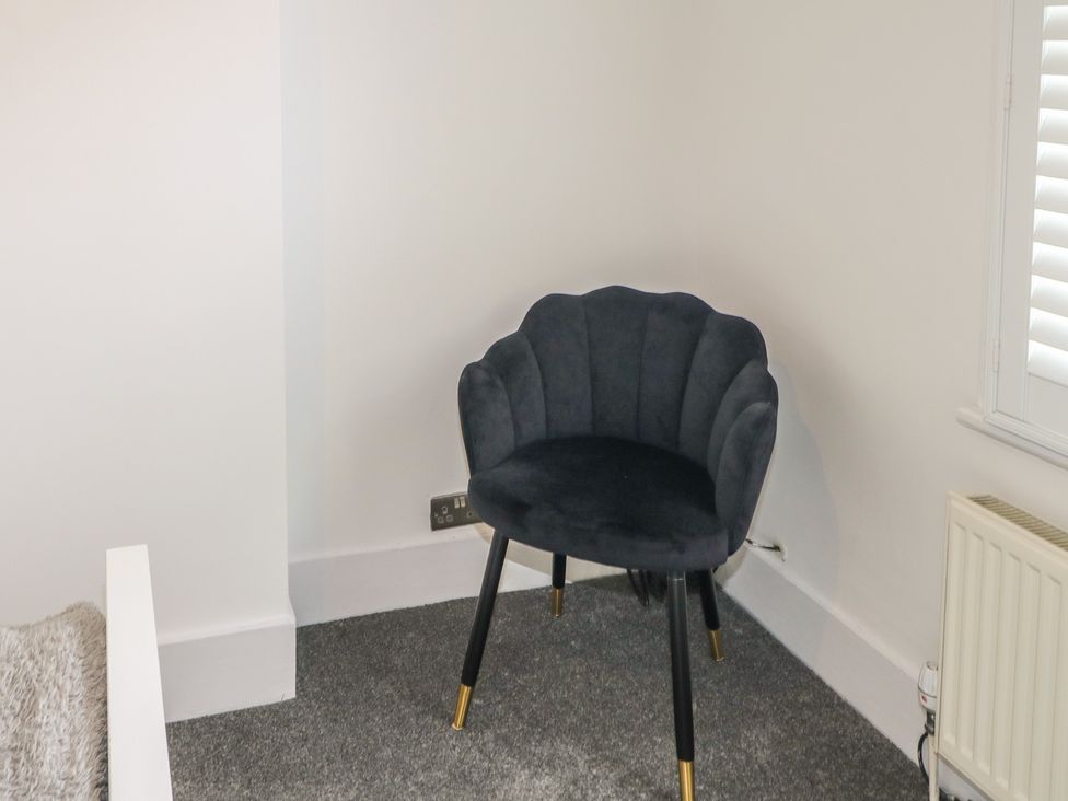 A chair in the corner of a bedroom at Foreshore in Deal