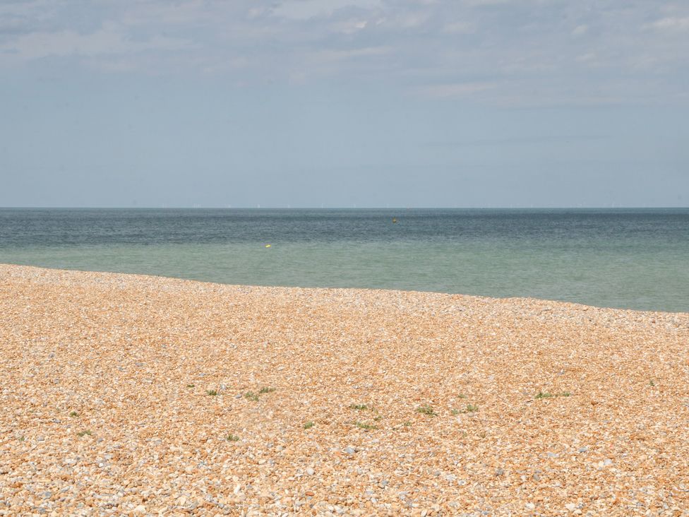 A beach with pebbles and water at Foreshore in Deal
