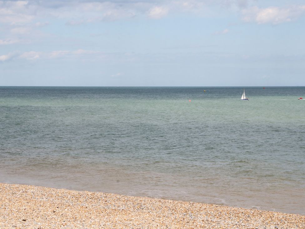 A view of the sea with a sailing boat at Foreshore in Deal