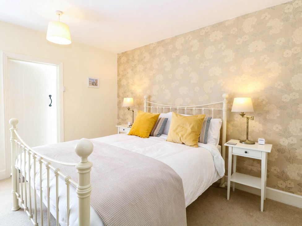 A bedroom with a bed and nightstand at 19 Covert Road in Reydon