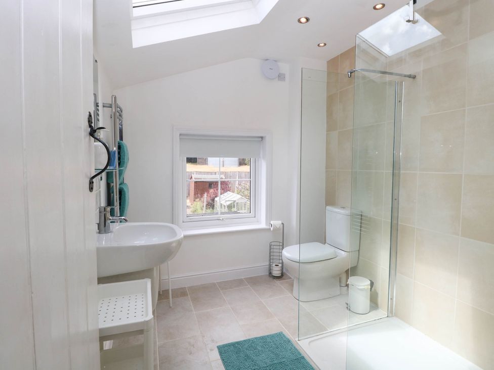 A bathroom with a shower and sink at 19 Covert Road in Reydon