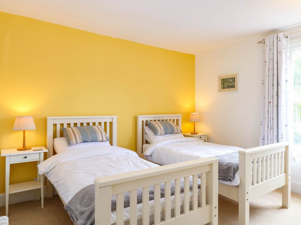 A bedroom with two single beds and a nightstand at 19 Covert Road, Reydon