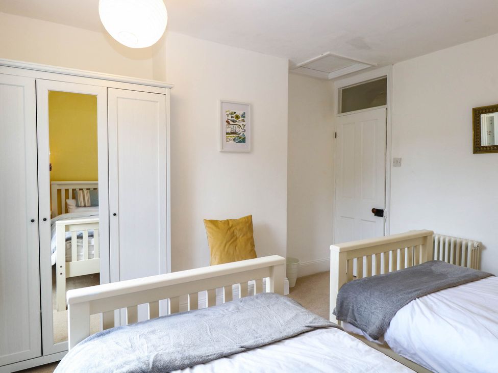 A bedroom with two beds and a wardrobe at 19 Covert Road in Reydon