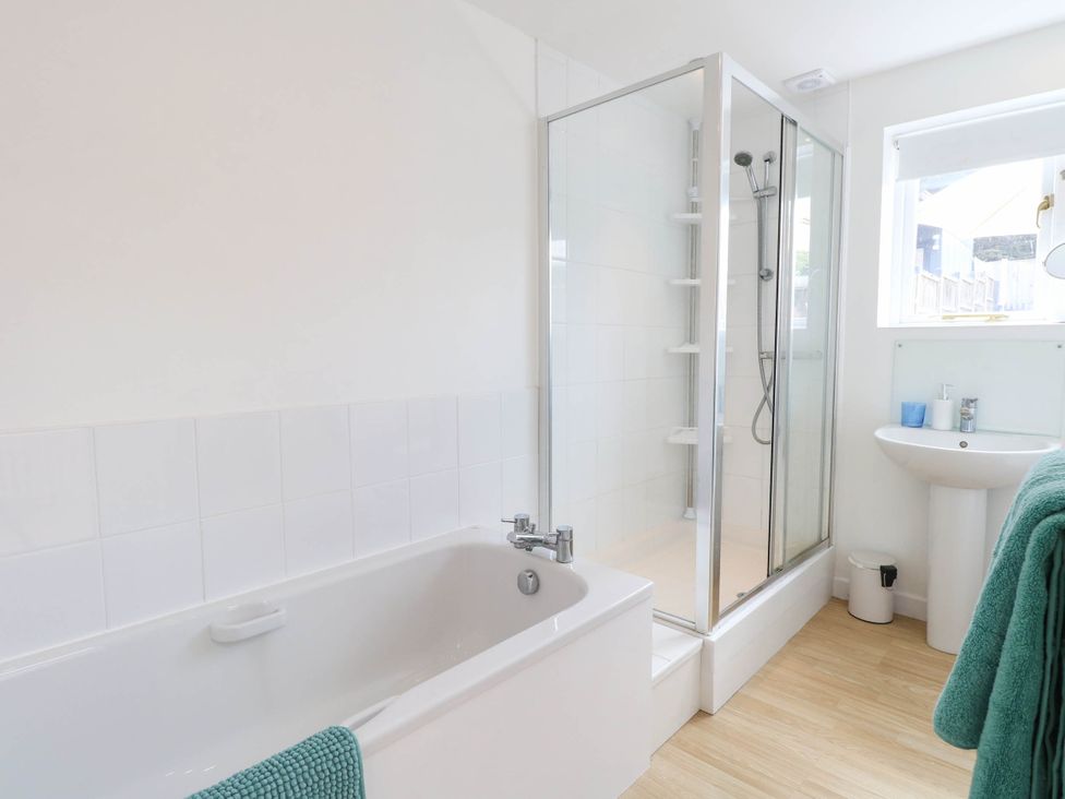 A bathroom with a bathtub and shower at 19 Covert Road, Reydon