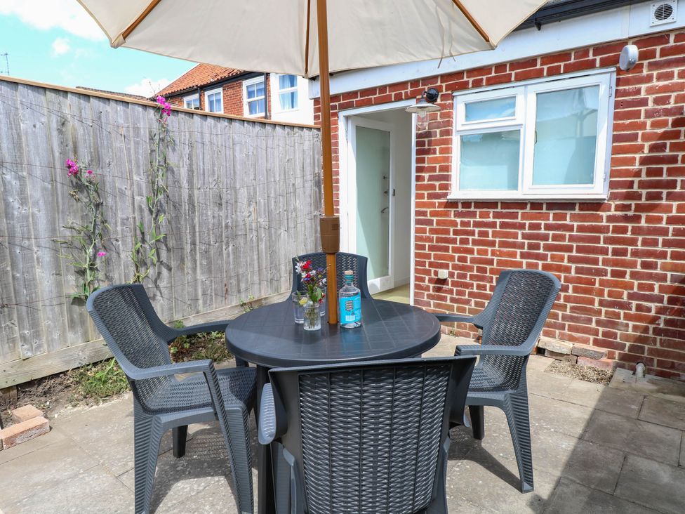 A garden with table and chairs in a patio area at 19 Covert Road in Reydon