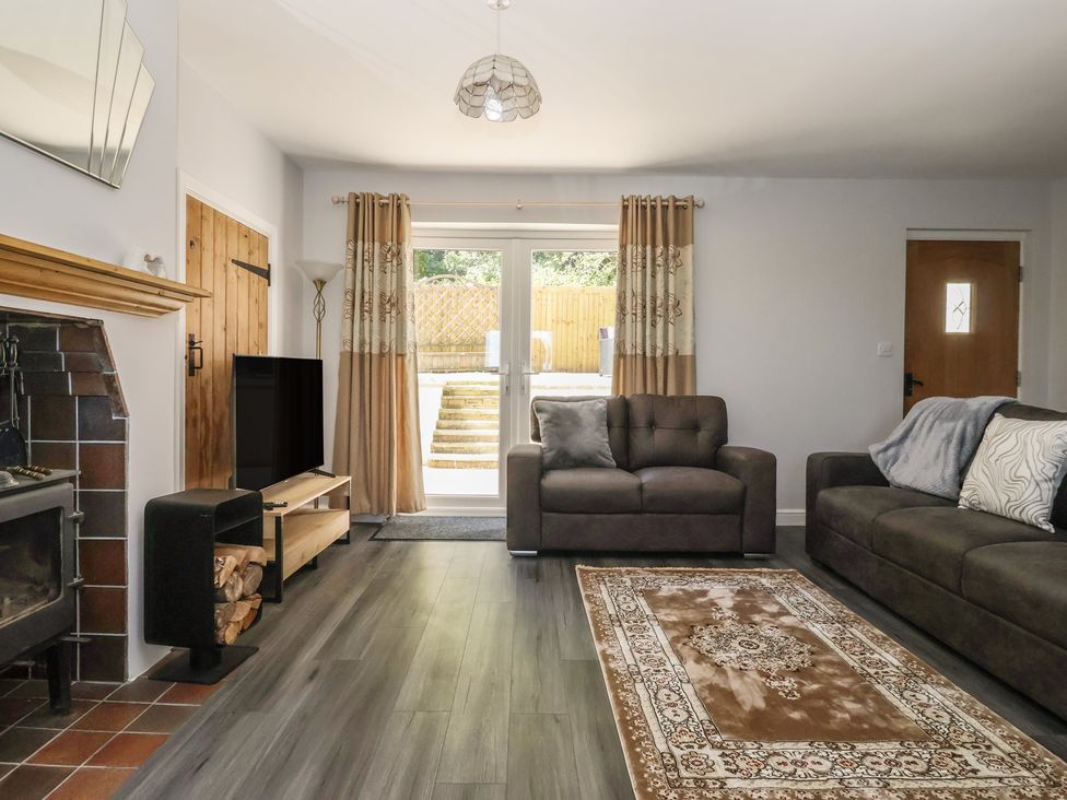 A living room with sofas and a TV at Sea View in Scarborough