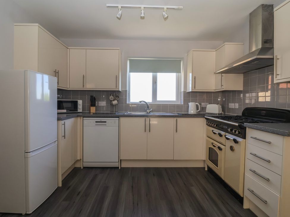 A kitchen with appliances including a refrigerator and oven at Sea View in Scarborough
