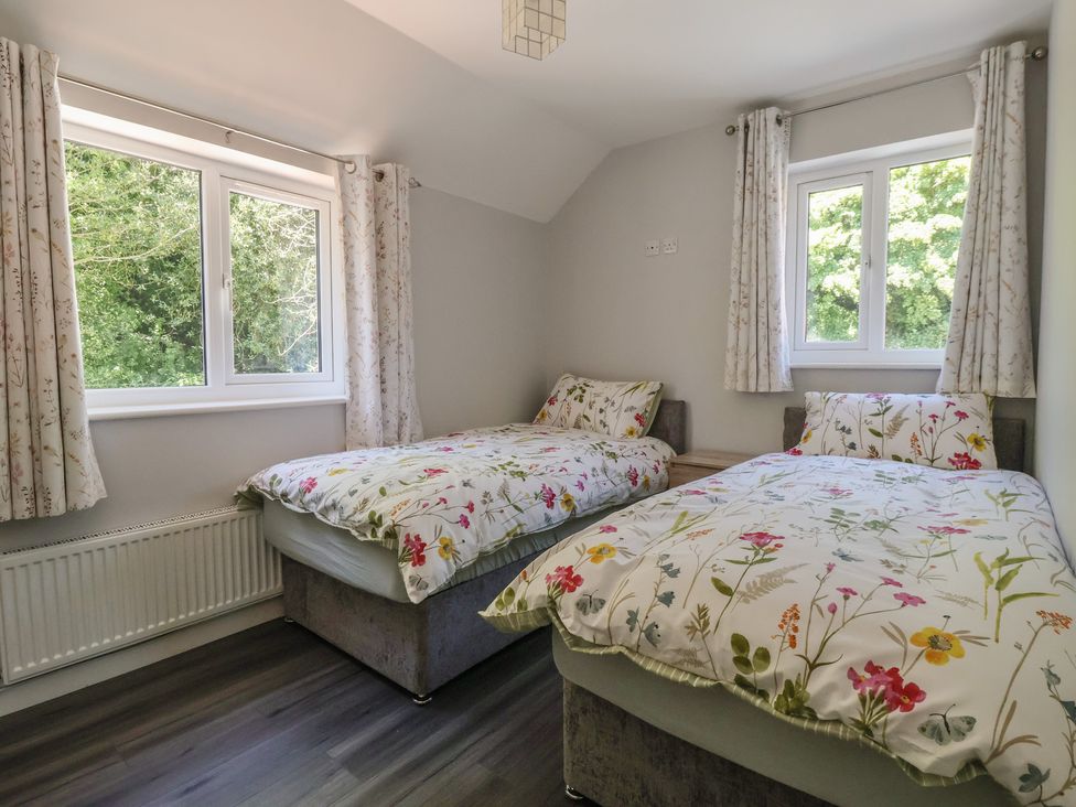 A bedroom with two beds and windows at Sea View in Scarborough