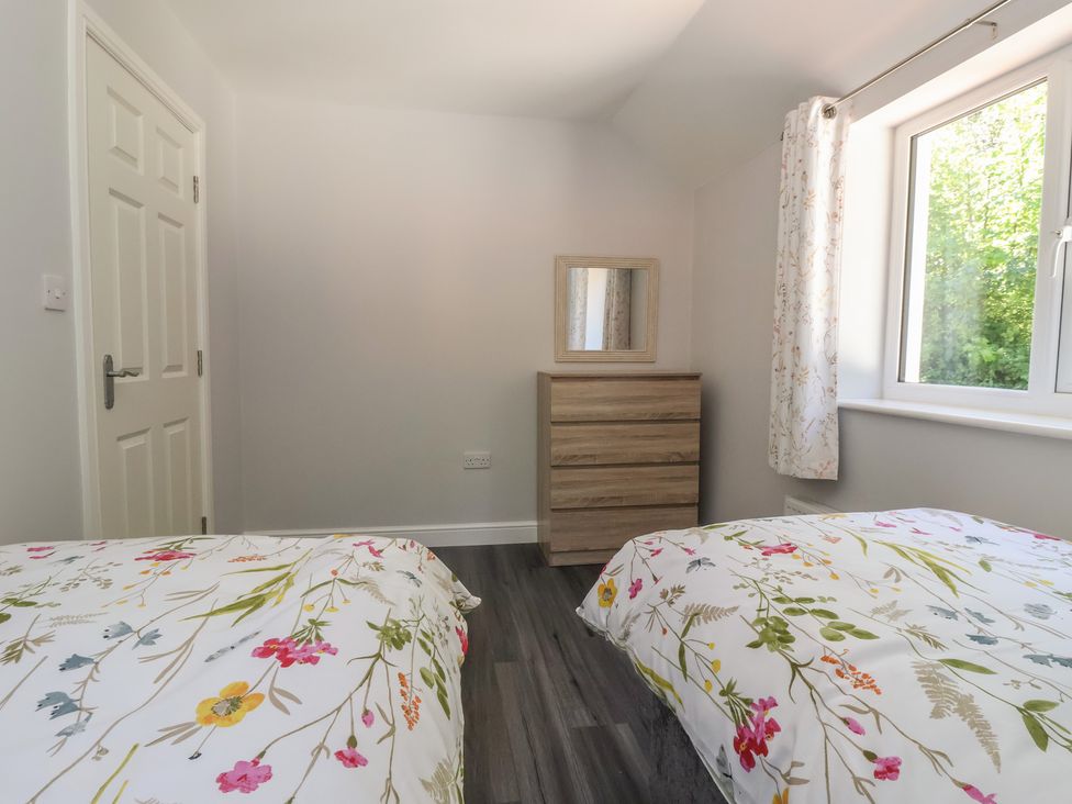 A bedroom with two beds and a dresser at Sea View in Scarborough