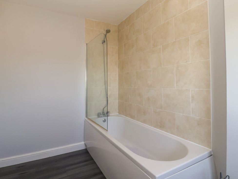 A bathroom with a bathtub and shower at Sea View in Scarborough