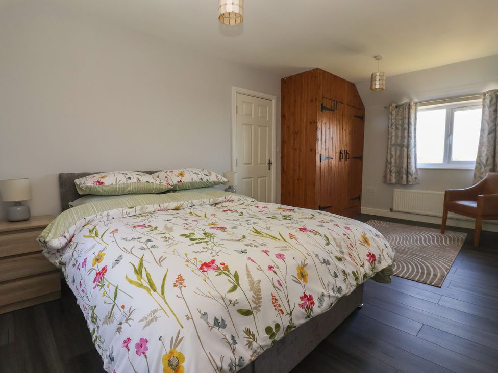 A bedroom with a bed and wardrobe at Sea View in Scarborough