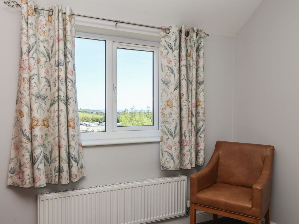 A bedroom with a window and chair at Sea View in Scarborough
