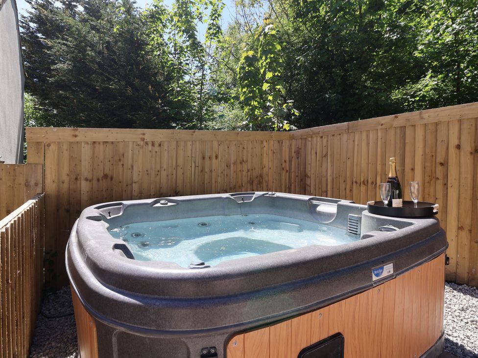 A hot tub with champagne and glasses at Sea View in Scarborough